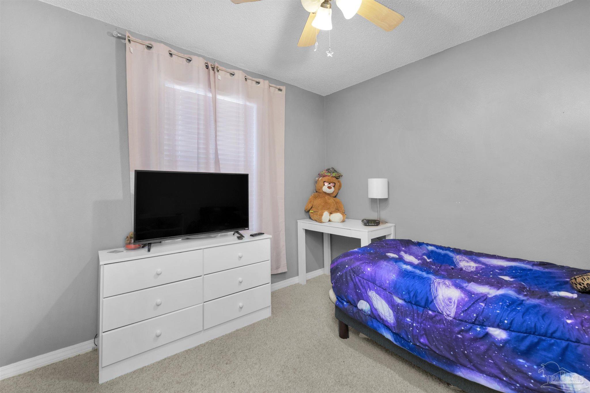 2702 Beacon Court Navarre, FL 32566 - Photo 22 of 29 a living room with furniture and a flat screen tv