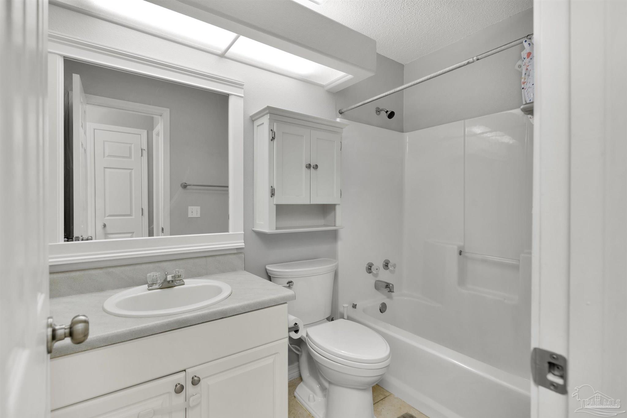 2702 Beacon Court Navarre, FL 32566 - Photo 23 of 29 a bathroom with a sink toilet a mirror and shower