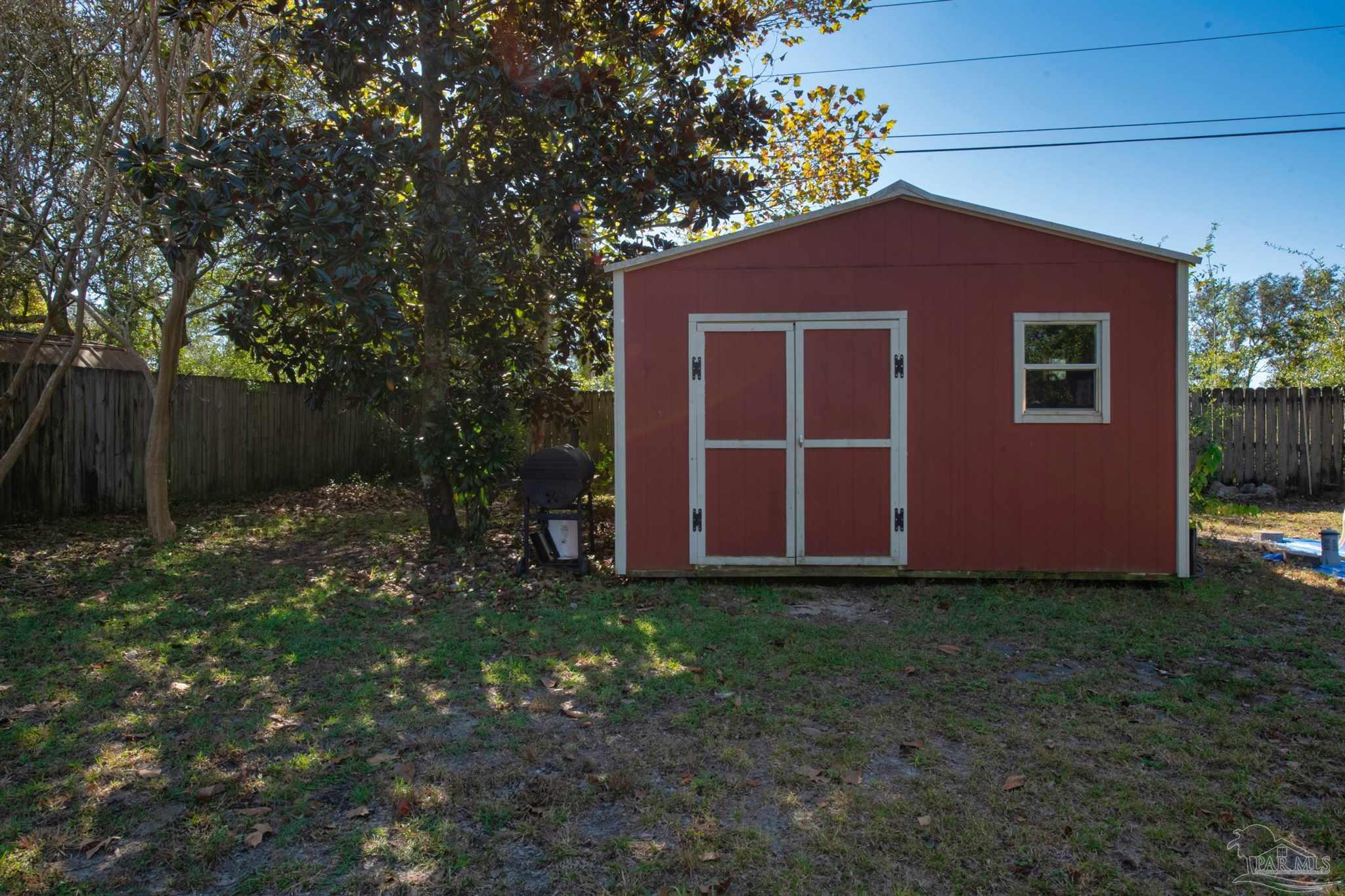 2702 Beacon Court Navarre, FL 32566 - Photo 25 of 29 a backyard of a house with lots of green space