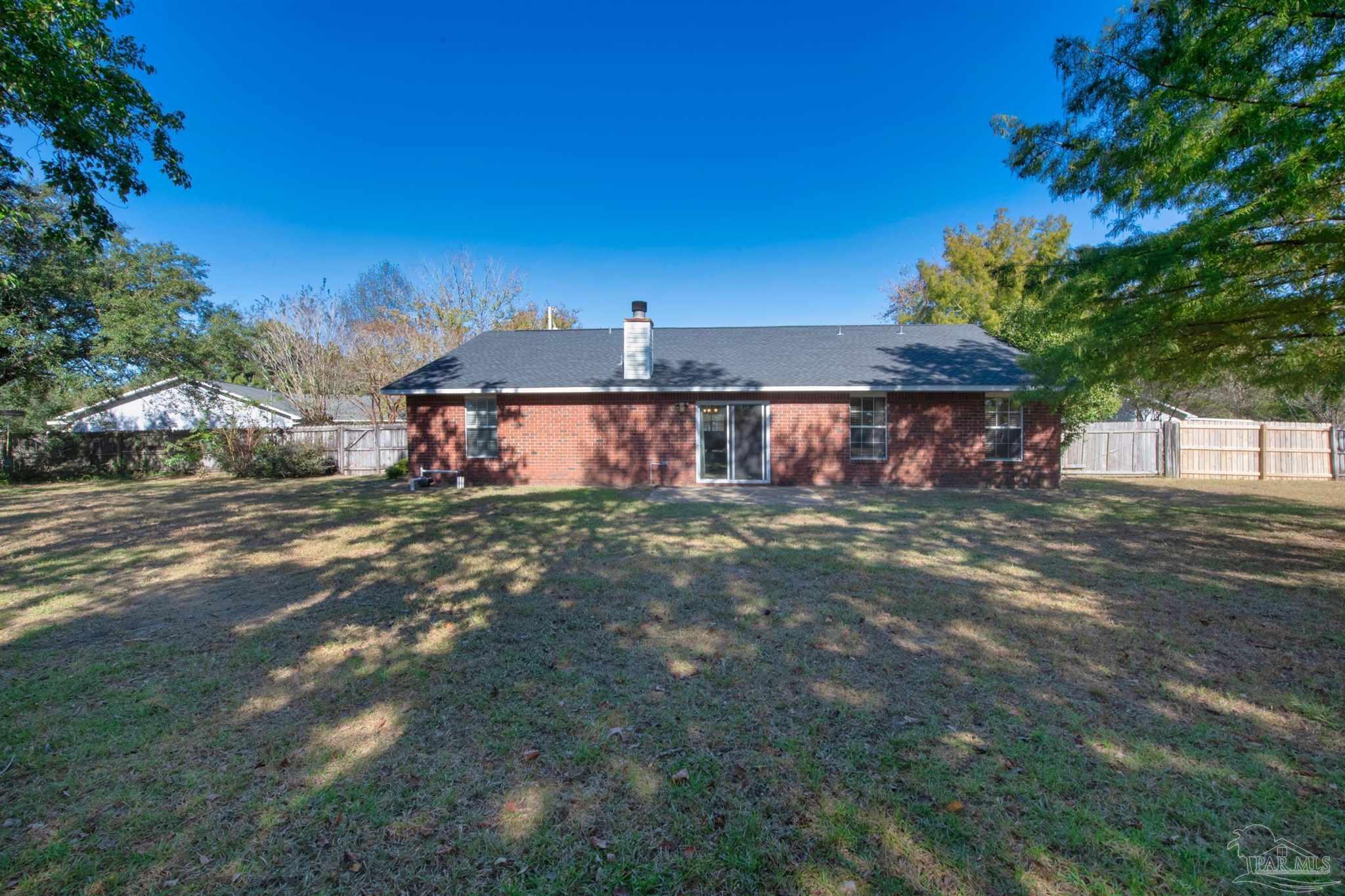 2702 Beacon Court Navarre, FL 32566 - Photo 26 of 29 a front view of a house with a garden