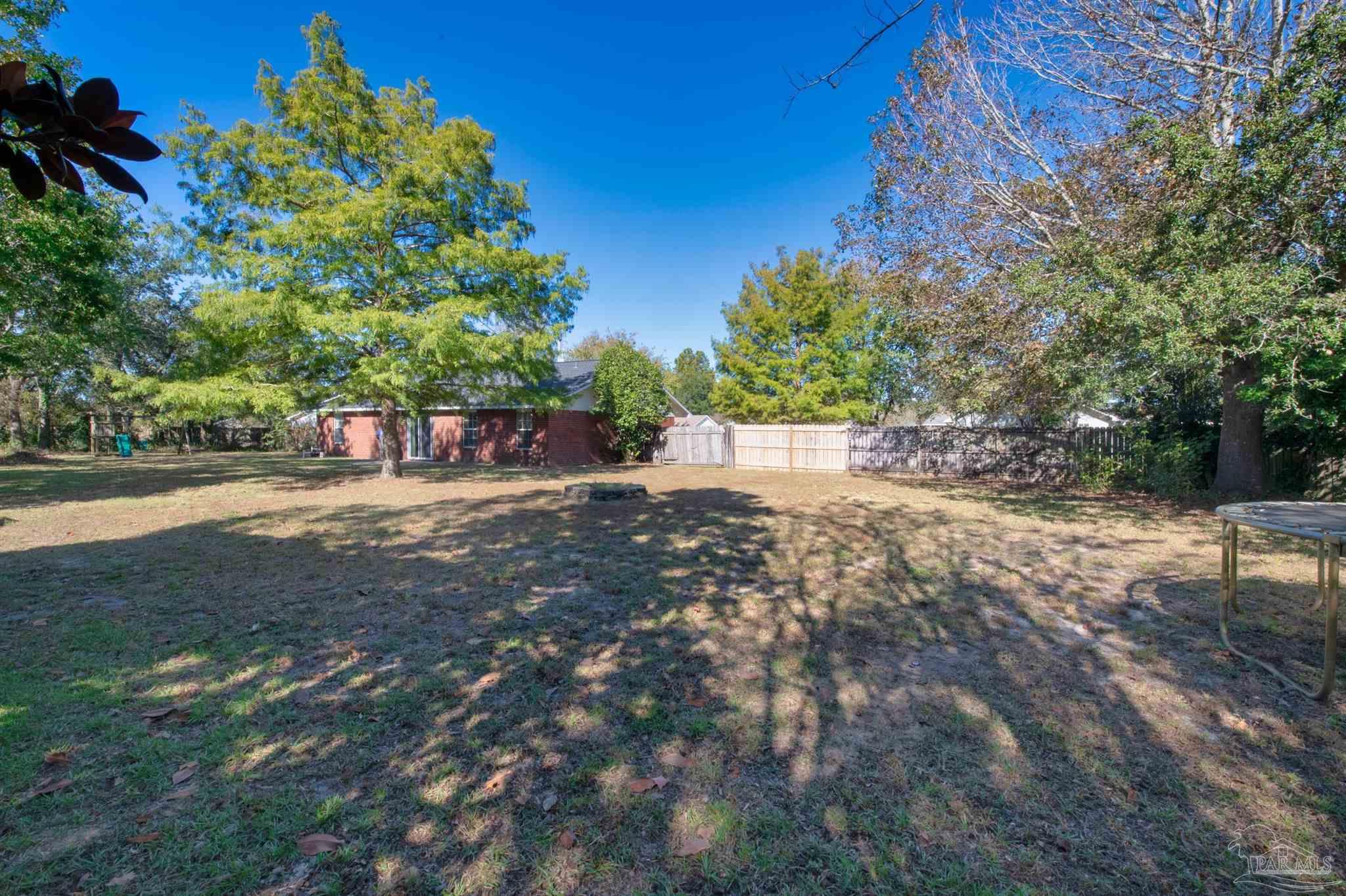 2702 Beacon Court Navarre, FL 32566 - Photo 27 of 29 a view of road and with trees