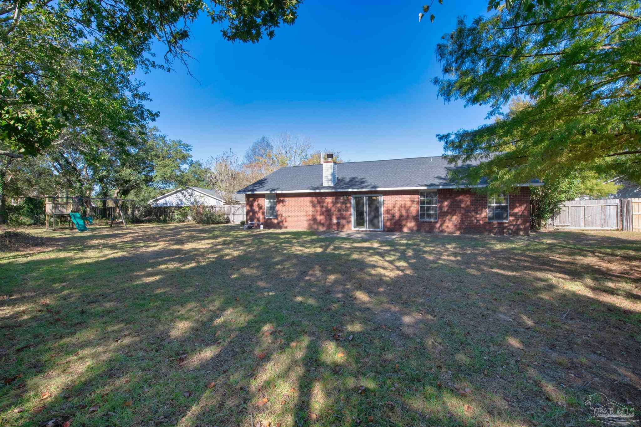 2702 Beacon Court Navarre, FL 32566 - Photo 28 of 29 a front view of a house with a yard and garage