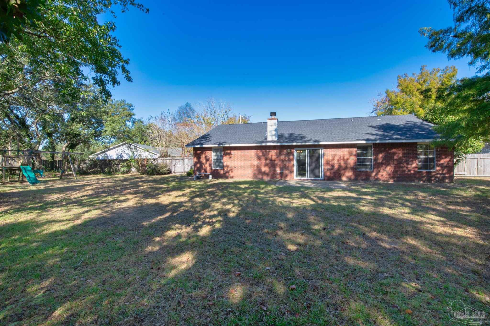 2702 Beacon Court Navarre, FL 32566 - Photo 29 of 29 a view of a house with a yard