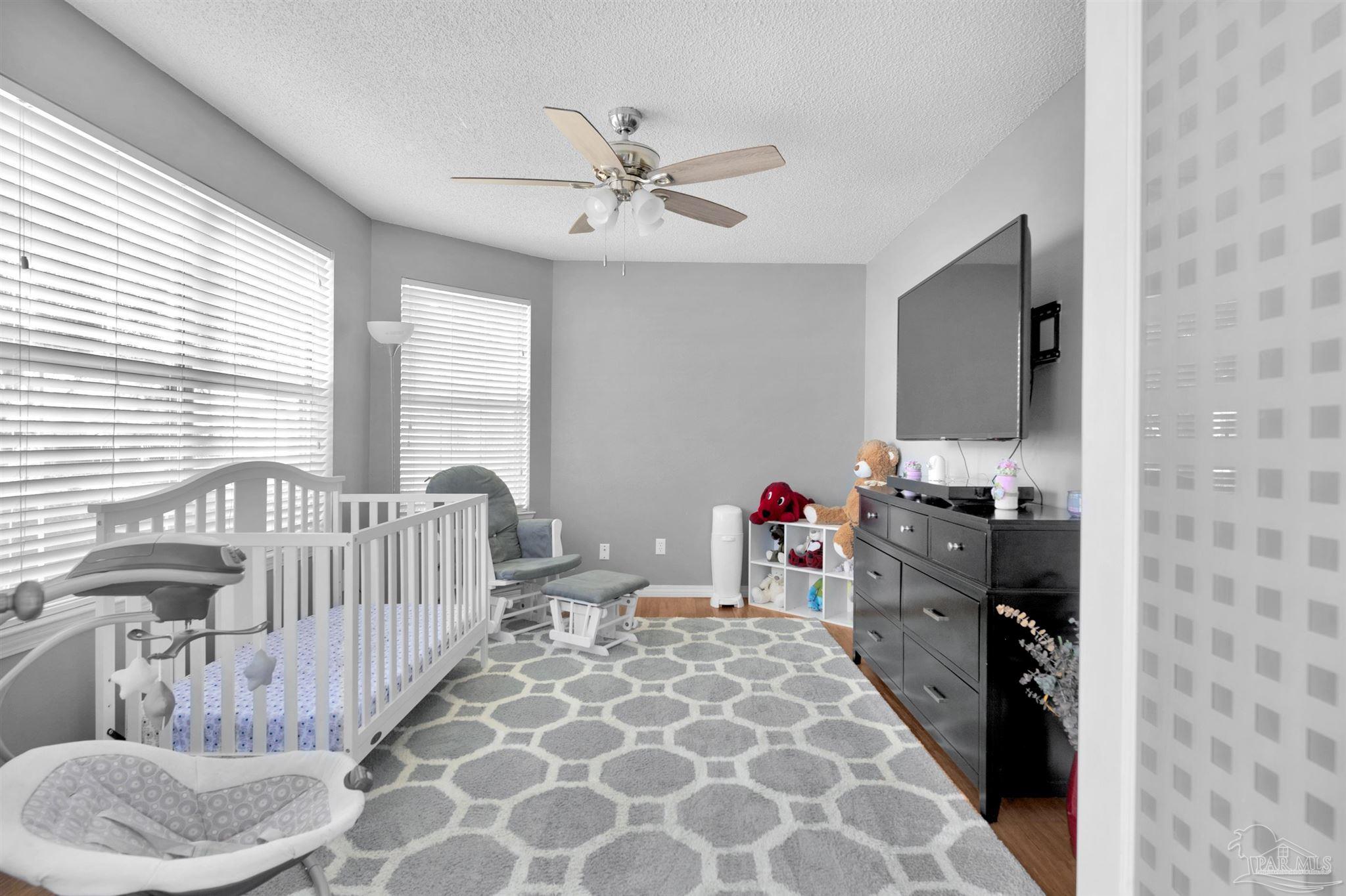 2702 Beacon Court Navarre, FL 32566 - Photo 7 of 29 a bedroom with furniture and a window