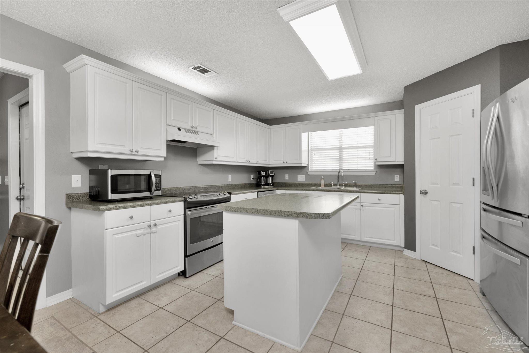 2702 Beacon Court Navarre, FL 32566 - Photo 8 of 29 a kitchen with a sink appliances and cabinets