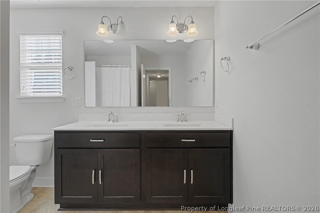 47 Pinnacle Drive Spring Lake, NC 28390 - Photo 30 of 50 a bathroom with a sink vanity and a mirror