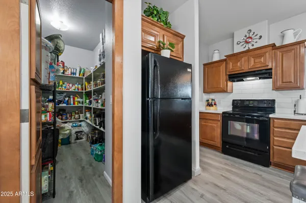 a kitchen with refrigerator and cabinets