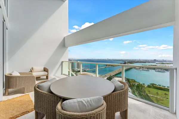 a balcony with table and chairs