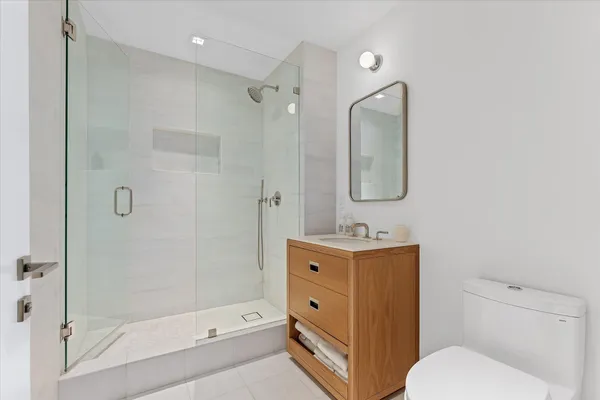 a bathroom with a toilet sink shower and mirror