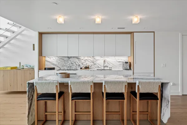 a kitchen with a table chairs sink and cabinets
