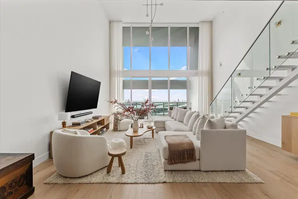 a living room with couches and a flat screen tv