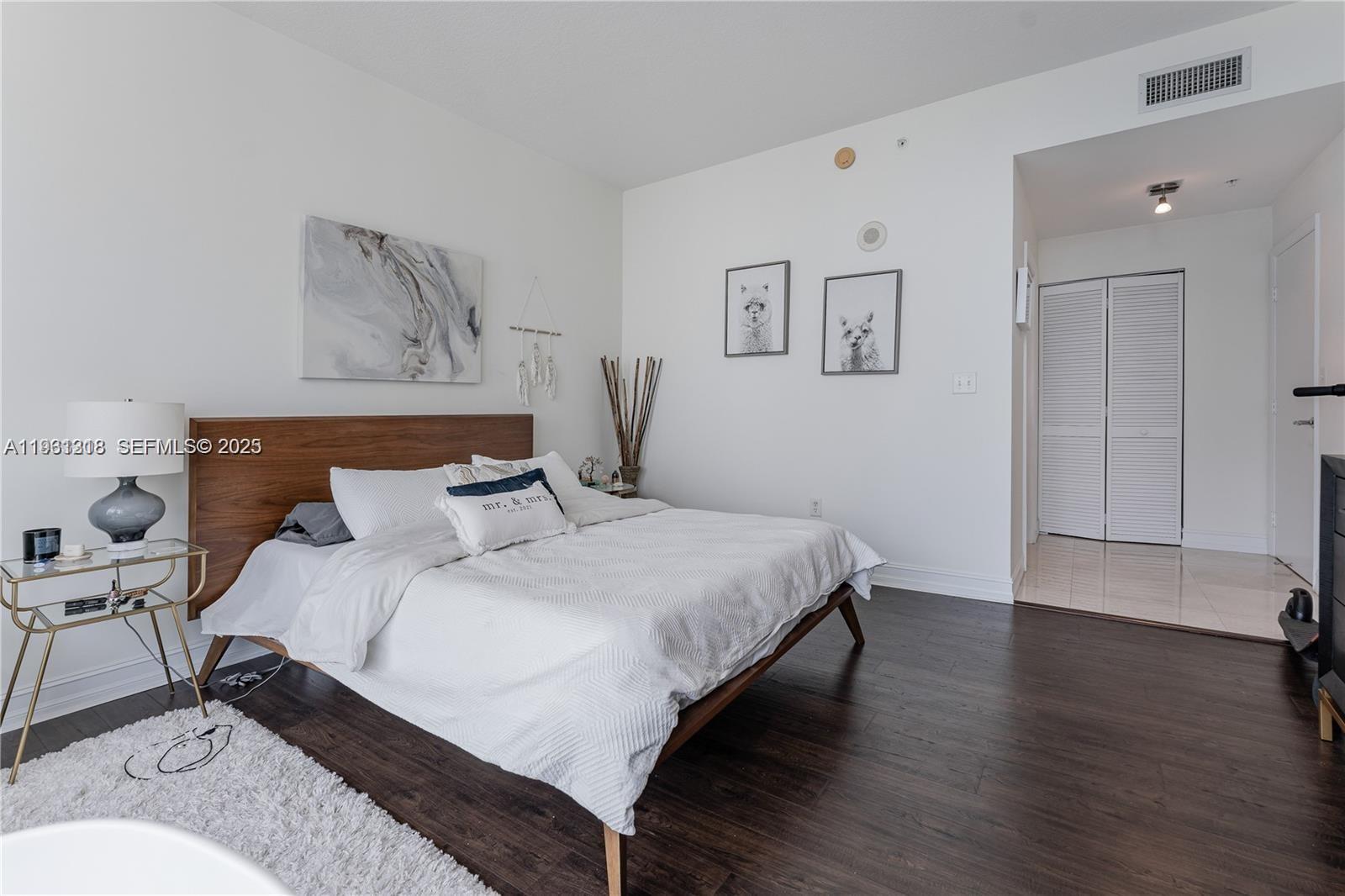 31 Southeast 5th Street, Unit 3716 Miami, FL 33131 - Photo 11 of 37 a bedroom with a bed and wooden floor