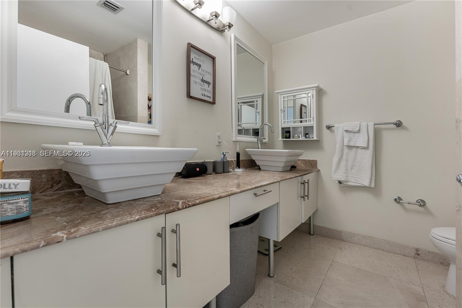 31 Southeast 5th Street, Unit 3716 Miami, FL 33131 - Photo 13 of 37 a bathroom with a granite countertop sink mirror and toilet