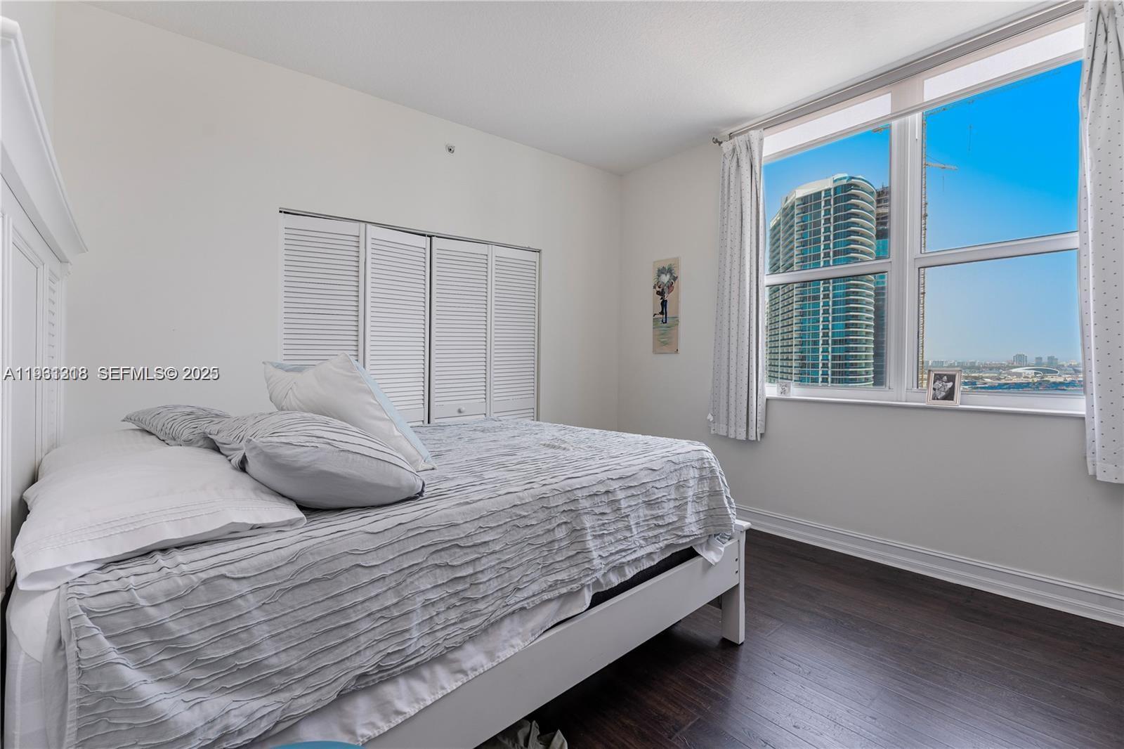 31 Southeast 5th Street, Unit 3716 Miami, FL 33131 - Photo 14 of 37 a bedroom with a bed and a window