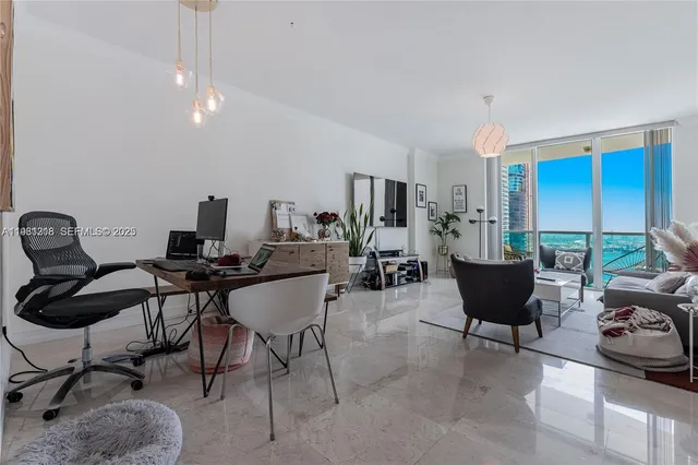 a living room with furniture and a work place