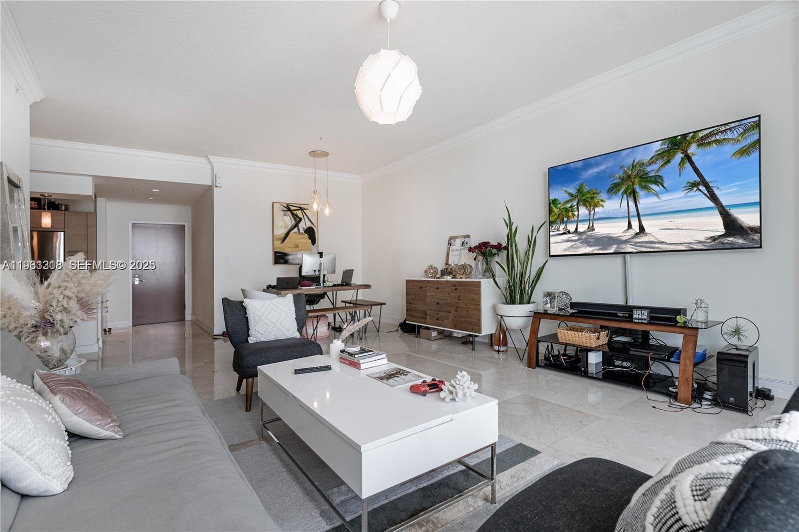 31 Southeast 5th Street, Unit 3716 Miami, FL 33131 - Photo 6 of 37 a living room with furniture a rug and a chandelier