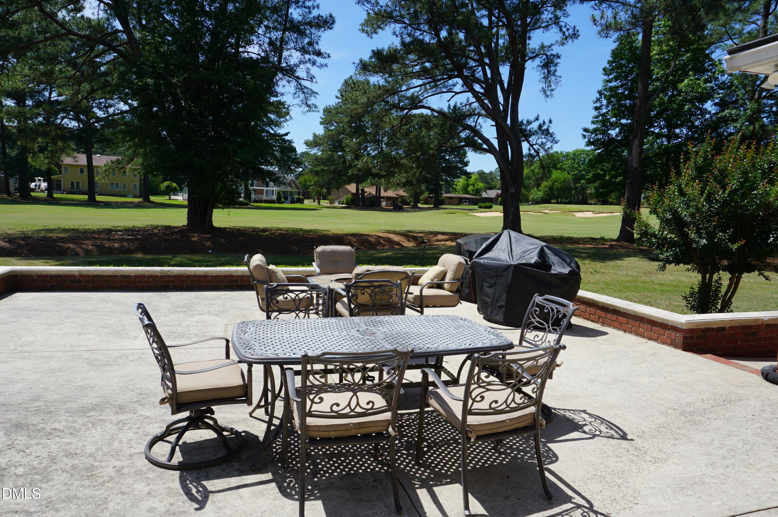 2125 Keith Hills Road Lillington, NC 27546 - Photo 62 of 66 a view of a patio with table and chairs and a fire pit