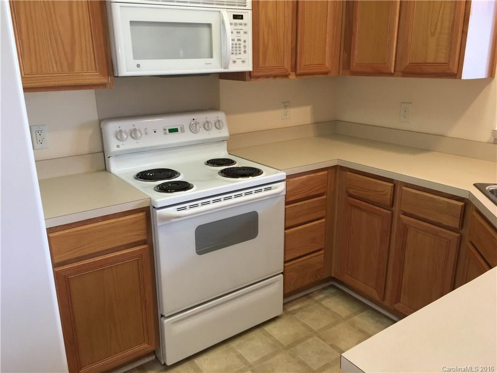 3062 Priory Ridge Drive Fort Mill, SC 29707 - Photo 3 of 24 a kitchen with a stove white cabinets and a refrigerator