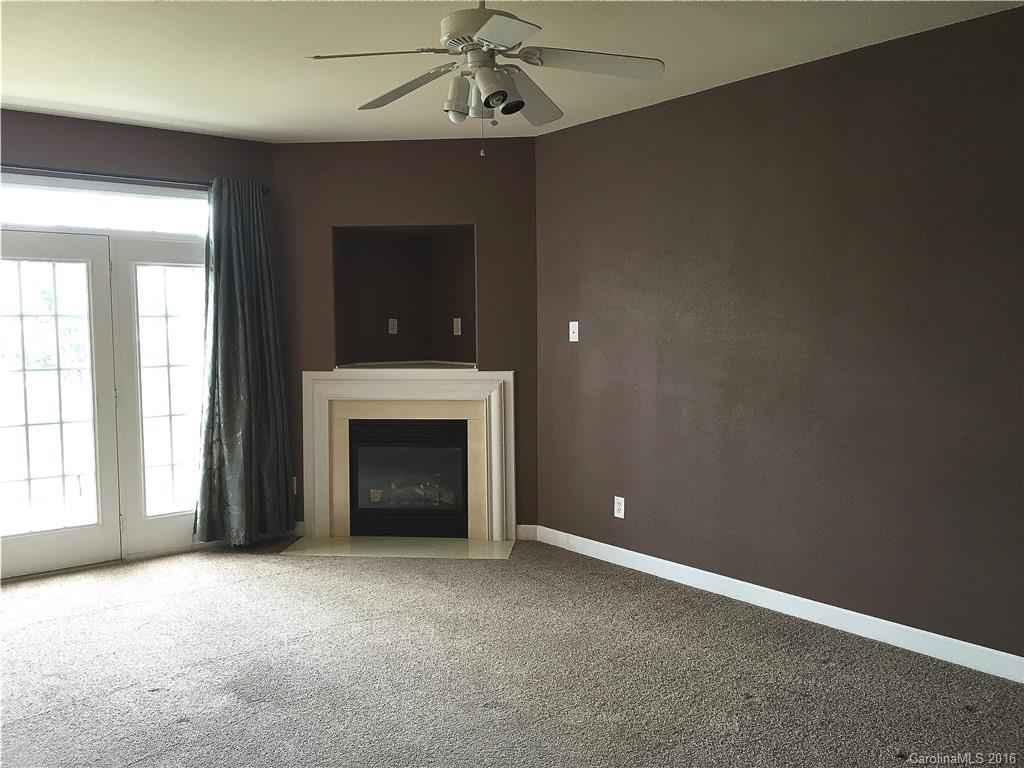 3062 Priory Ridge Drive Fort Mill, SC 29707 - Photo 6 of 24 an empty room with windows and fireplace
