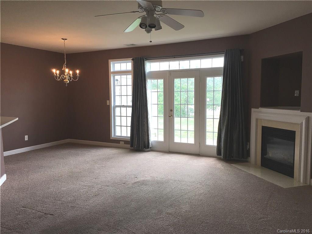 3062 Priory Ridge Drive Fort Mill, SC 29707 - Photo 7 of 24 a view of an empty room with a fireplace and a window