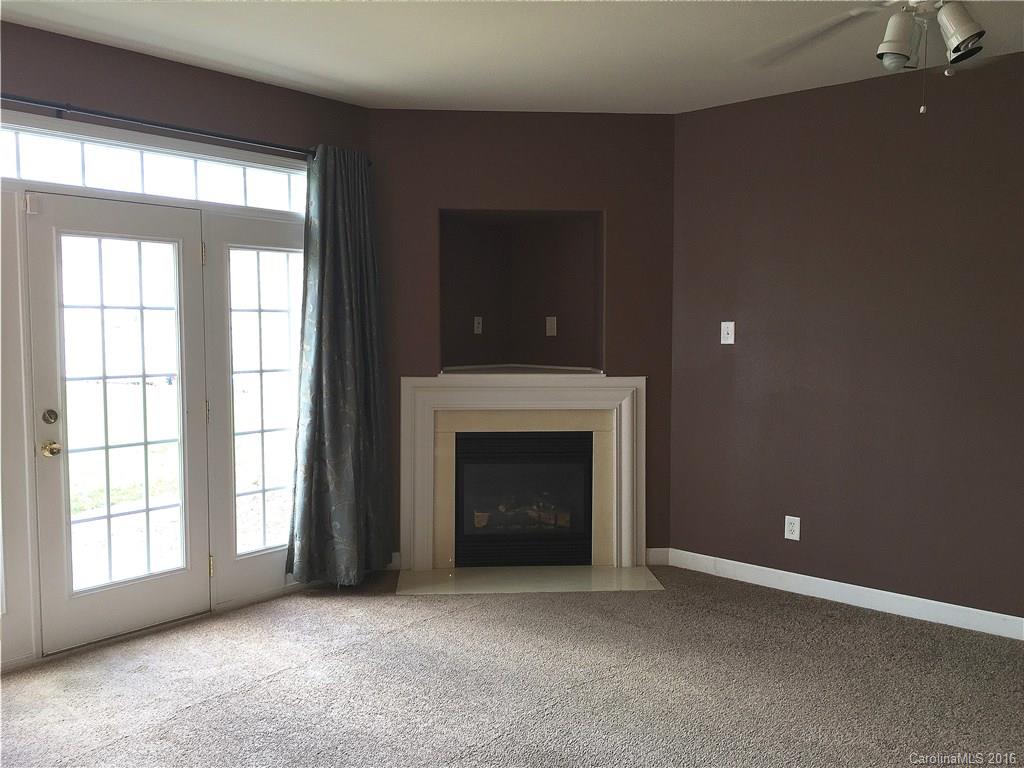 3062 Priory Ridge Drive Fort Mill, SC 29707 - Photo 8 of 24 an empty room with fireplace and windows
