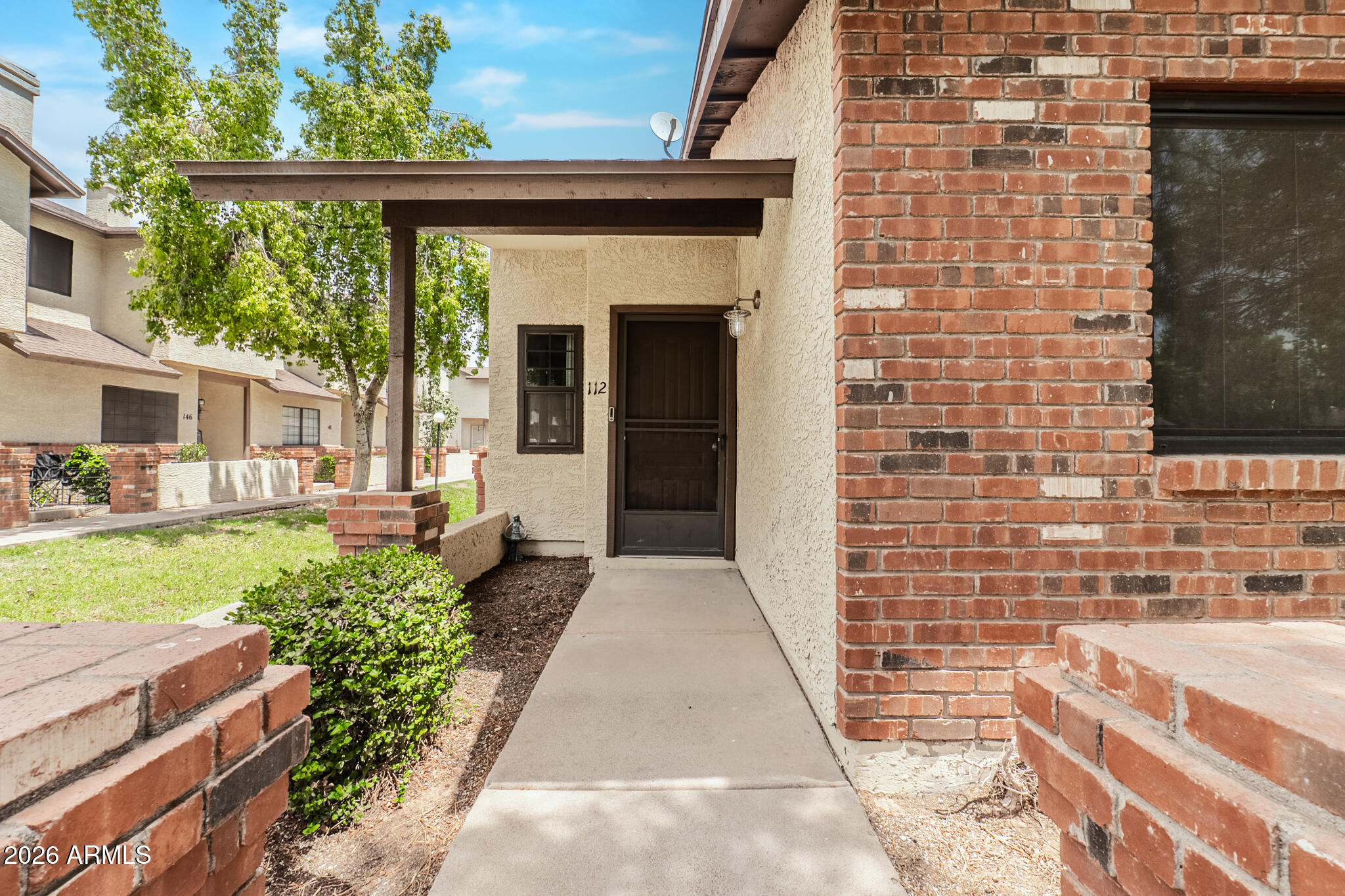 170 East Guadalupe Road, Unit 112 Gilbert, AZ 85234 - Photo 2 of 22 a pathway of a house with a yard