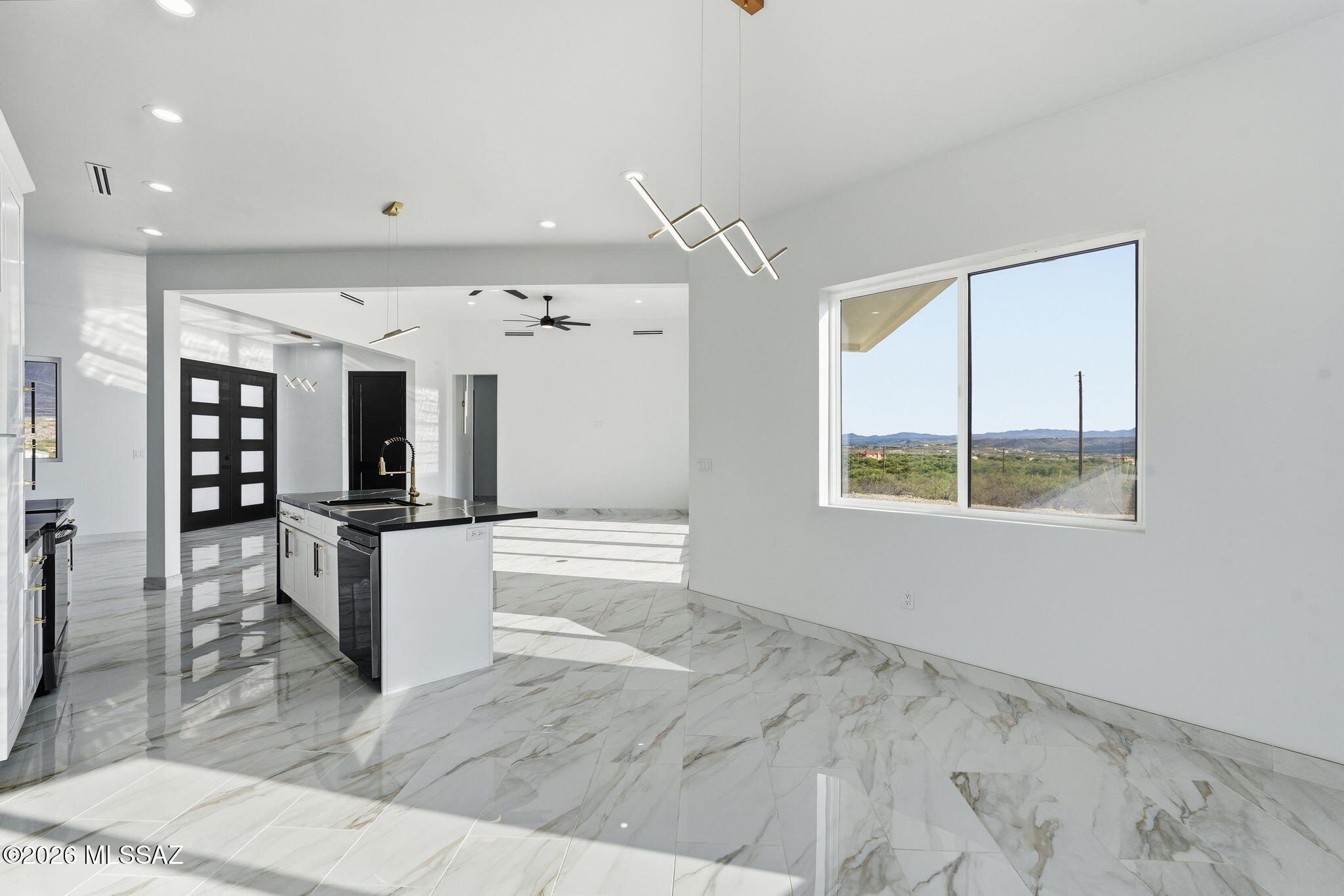 1786 Peralta Court Rio Rico, AZ 85648 - Photo 23 of 50 a kitchen with stainless steel appliances kitchen island granite countertop a refrigerator and a sink