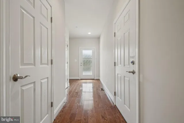 a view of a kitchen with wooden floor and a window