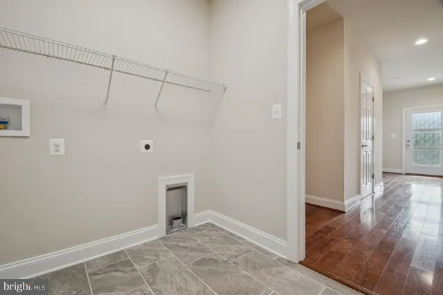 a kitchen with a stove and living room