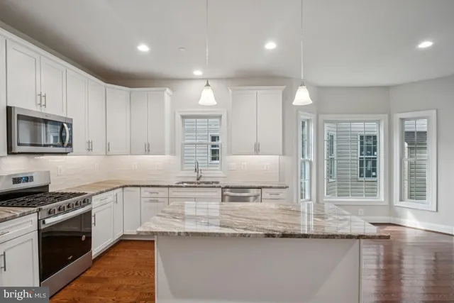 a stove top oven sitting inside of a kitchen