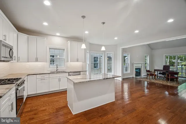 a living room with furniture a dining table and a fireplace