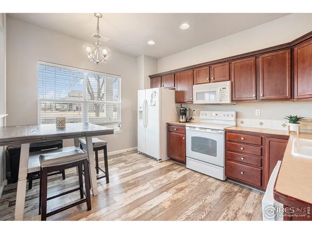 a kitchen with a stove a sink and a refrigerator