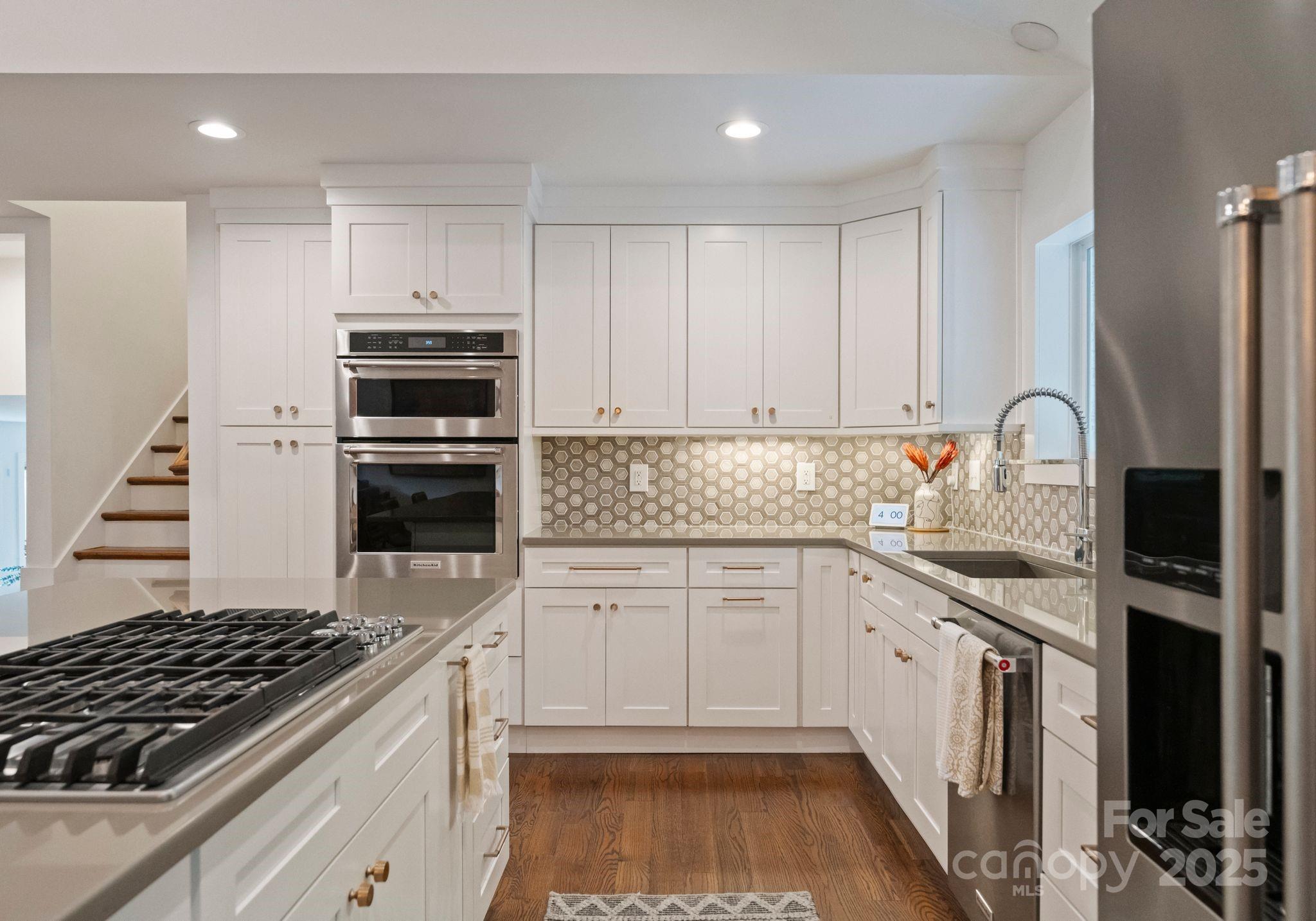 6527 Burlwood Road Charlotte, NC 28211 - Photo 12 of 43 a kitchen with granite countertop a sink stove and cabinets