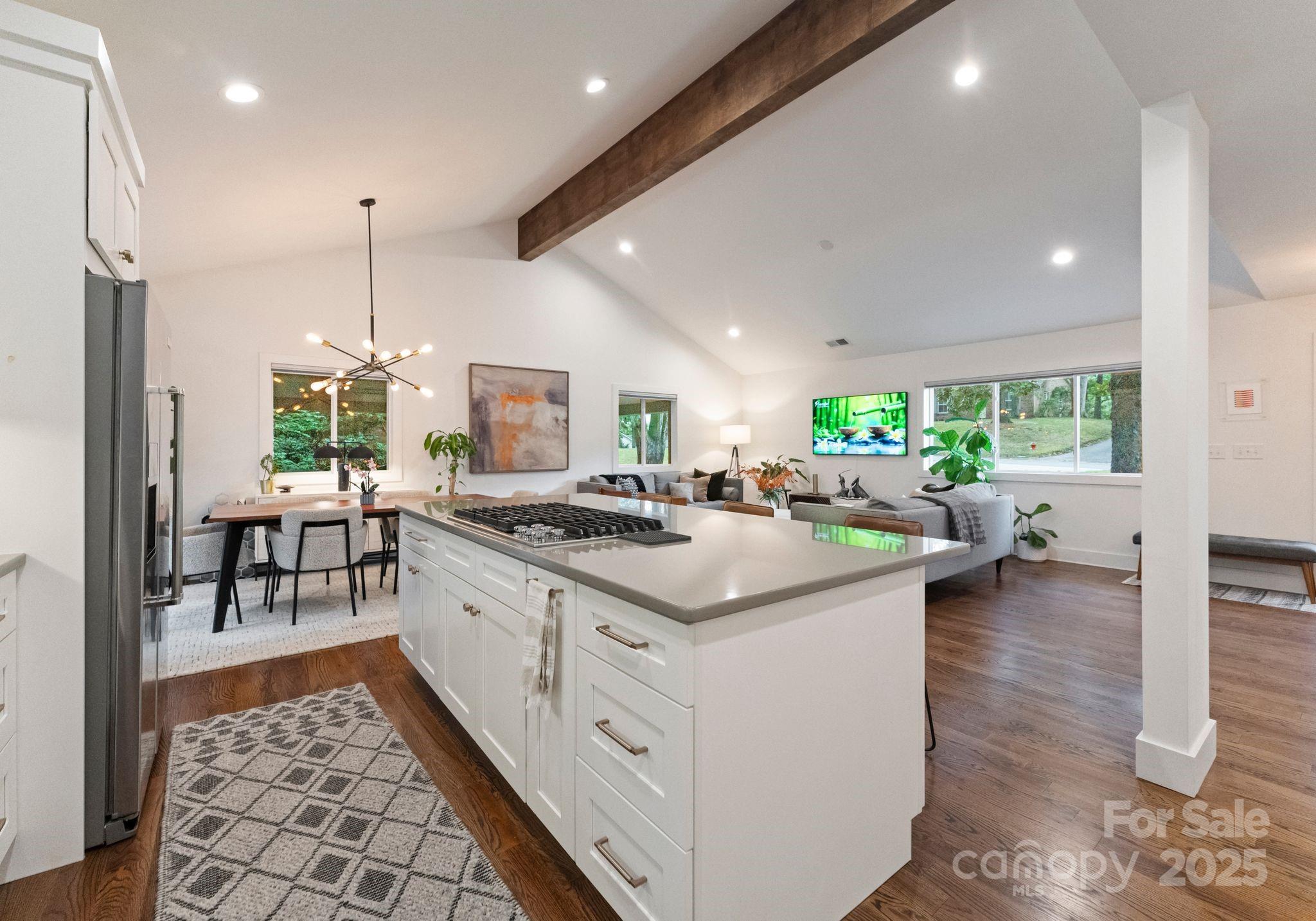 6527 Burlwood Road Charlotte, NC 28211 - Photo 14 of 43 a kitchen with a stove and a dining table with wooden floor