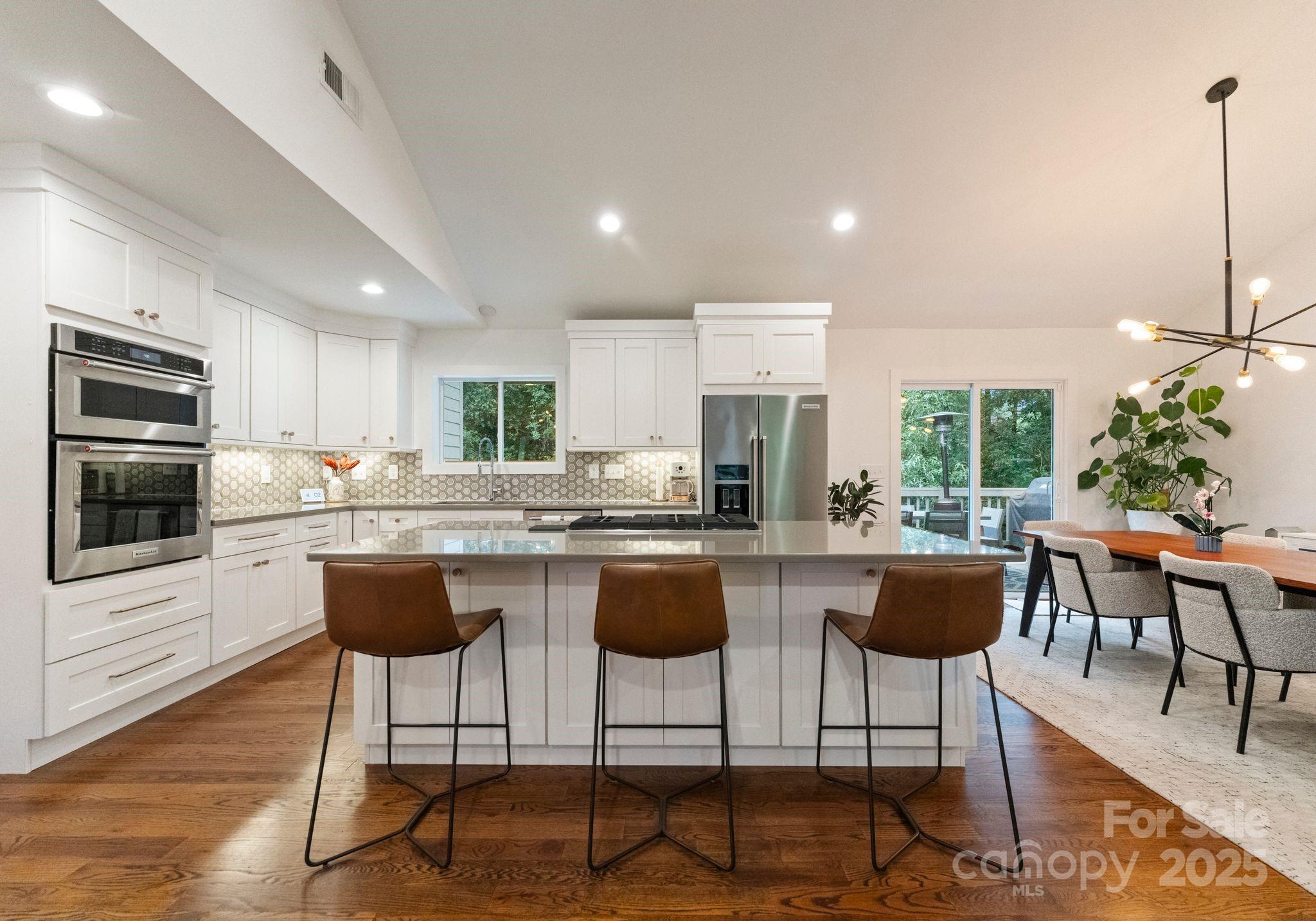 6527 Burlwood Road Charlotte, NC 28211 - Photo 18 of 43 a kitchen with a table chairs stove and cabinets