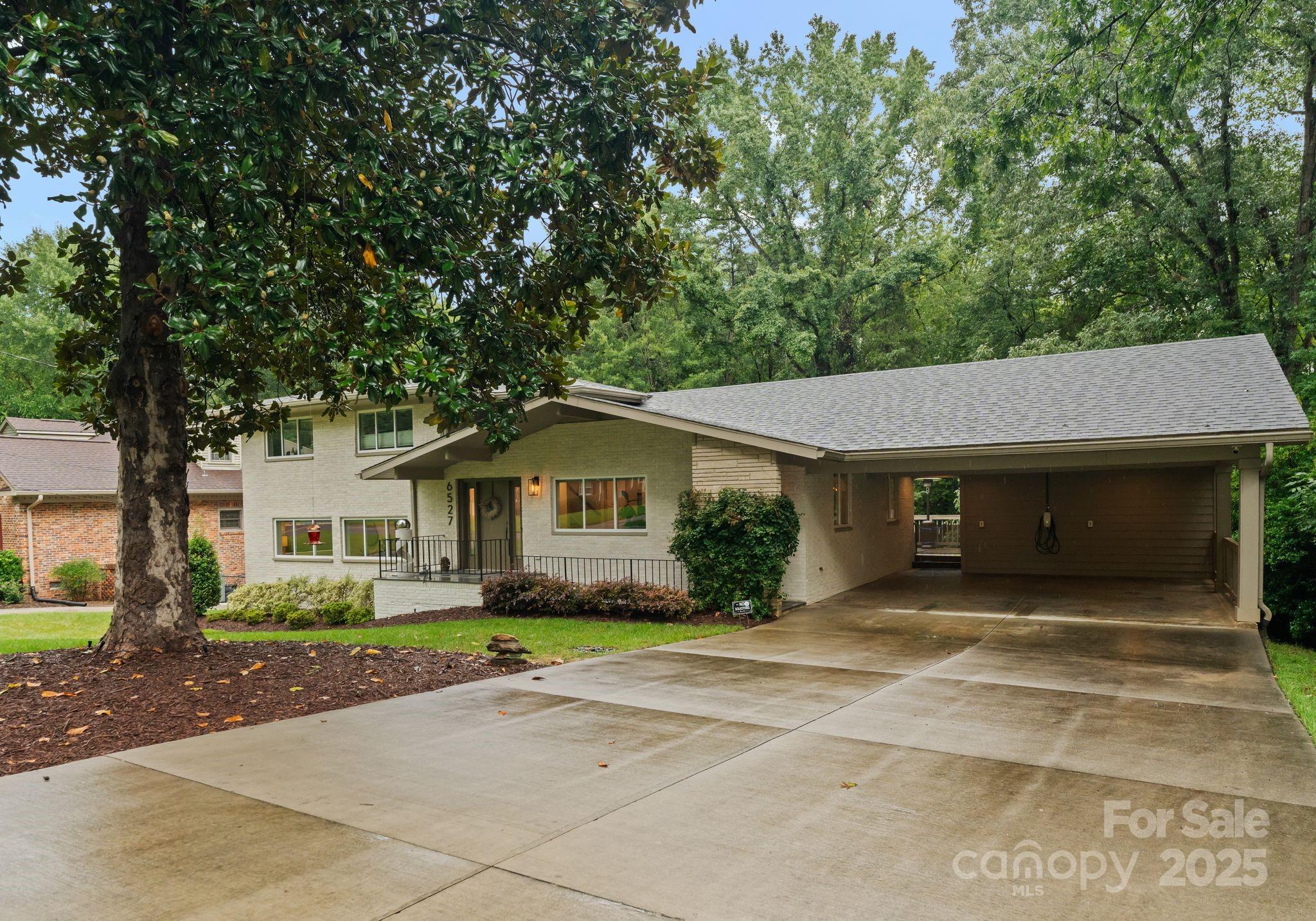 6527 Burlwood Road Charlotte, NC 28211 - Photo 2 of 43 a front view of a house with a garden