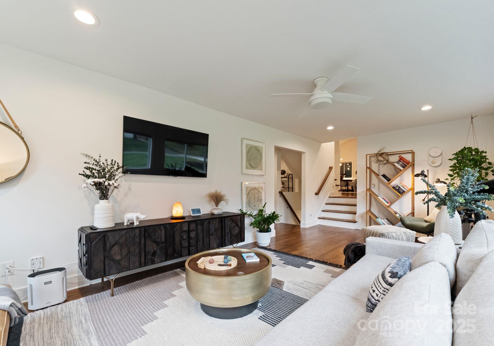 6527 Burlwood Road Charlotte, NC 28211 - Photo 21 of 43 a living room with furniture a flat screen tv and a mirror