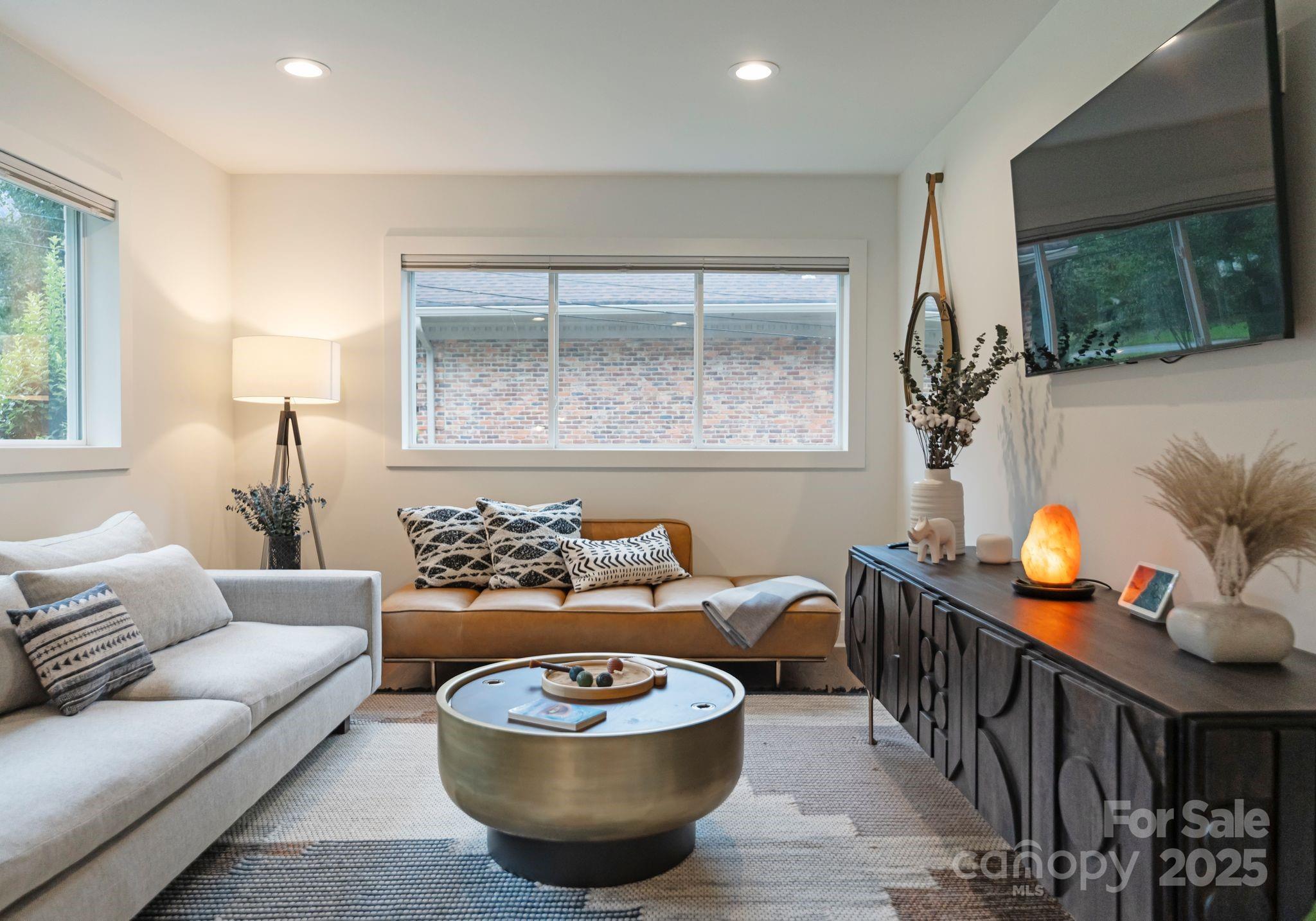 6527 Burlwood Road Charlotte, NC 28211 - Photo 22 of 43 a living room with furniture and a flat screen tv