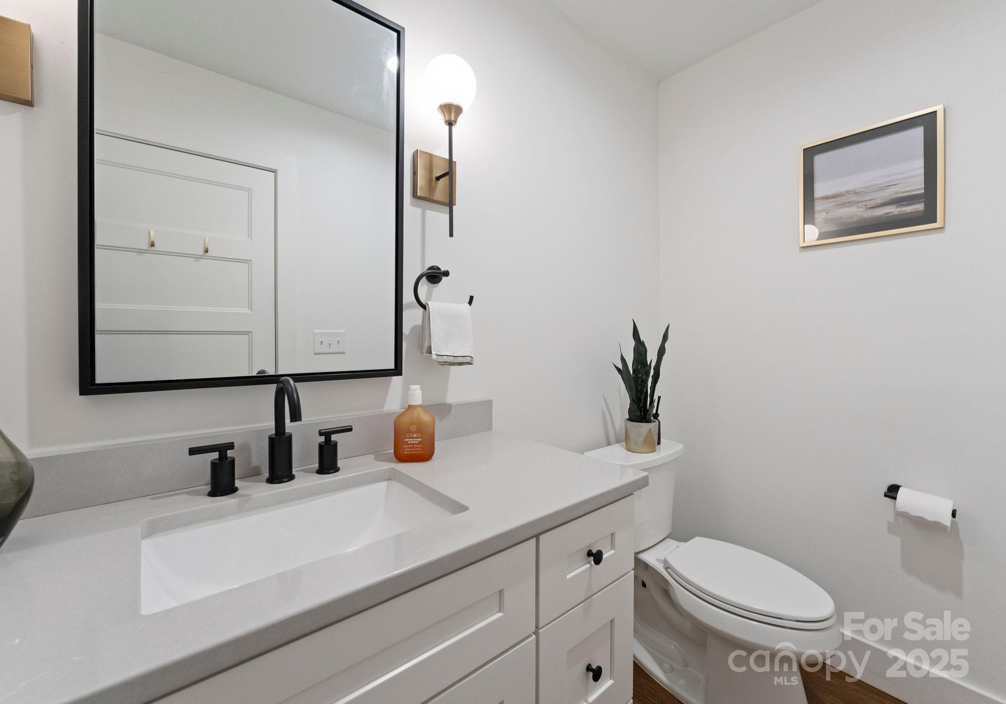 6527 Burlwood Road Charlotte, NC 28211 - Photo 23 of 43 a bathroom with a toilet sink and mirror