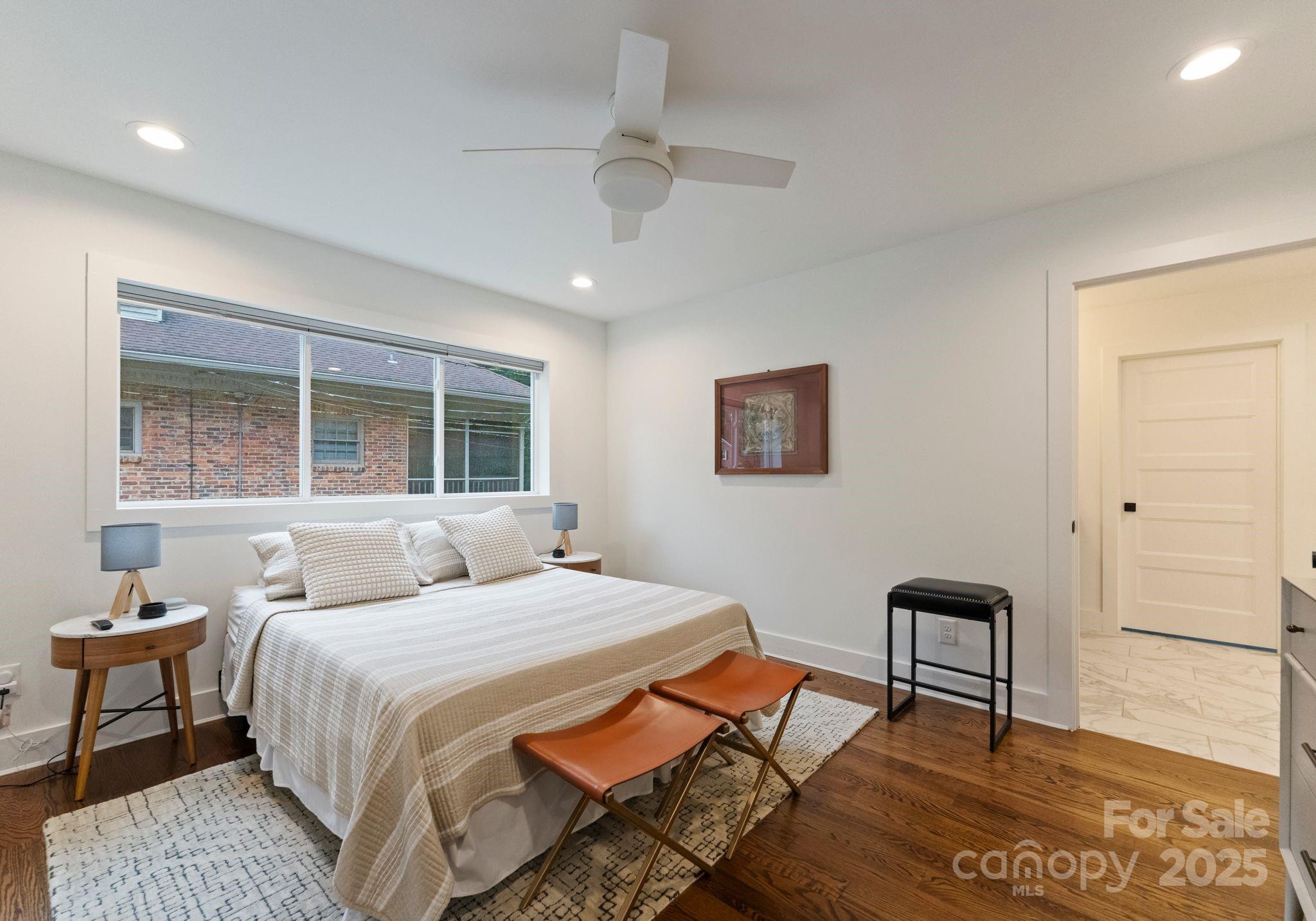 6527 Burlwood Road Charlotte, NC 28211 - Photo 24 of 43 a bedroom with a bed a chair and next to a window