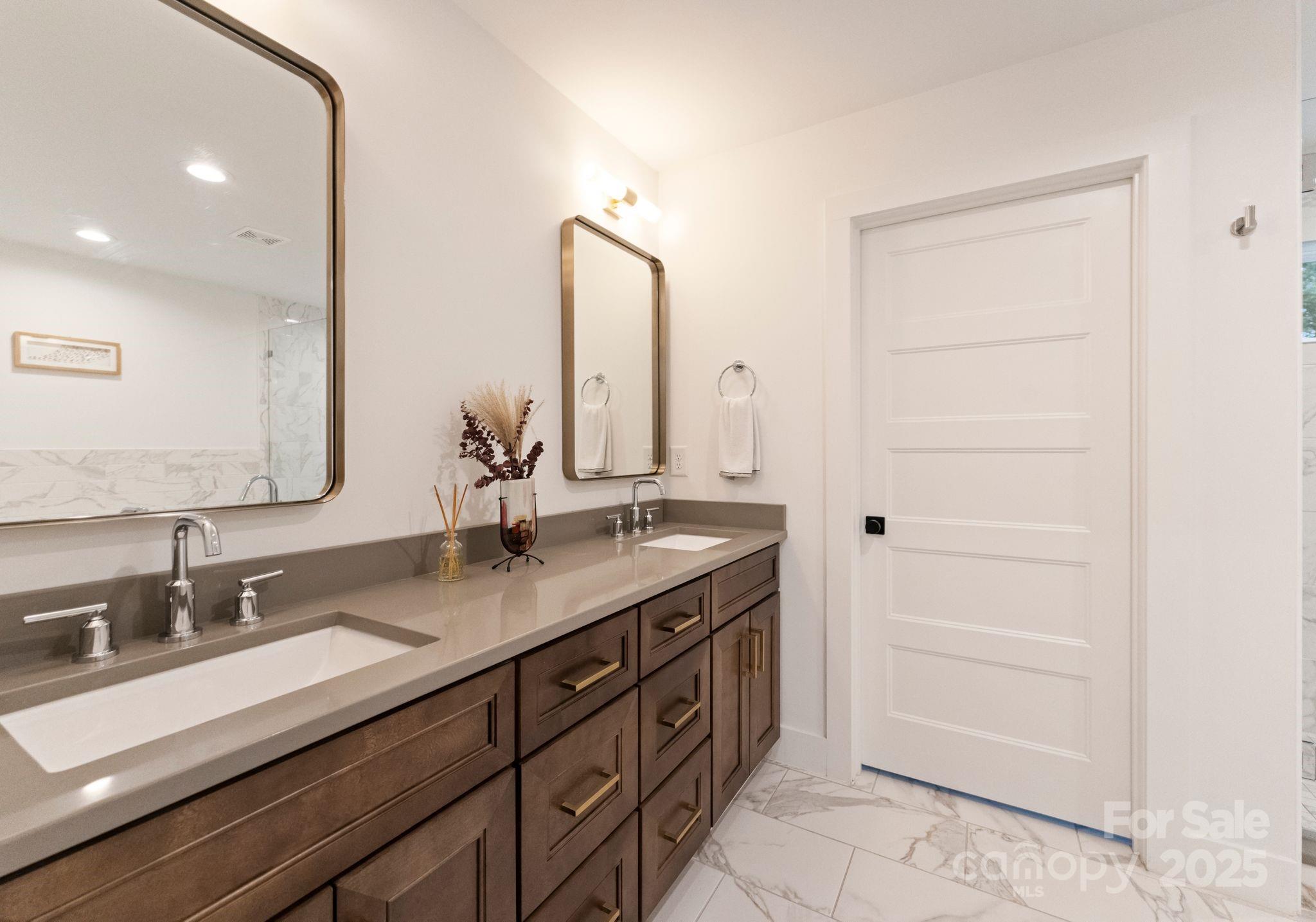 6527 Burlwood Road Charlotte, NC 28211 - Photo 25 of 43 a bathroom with a double vanity sink and a mirror