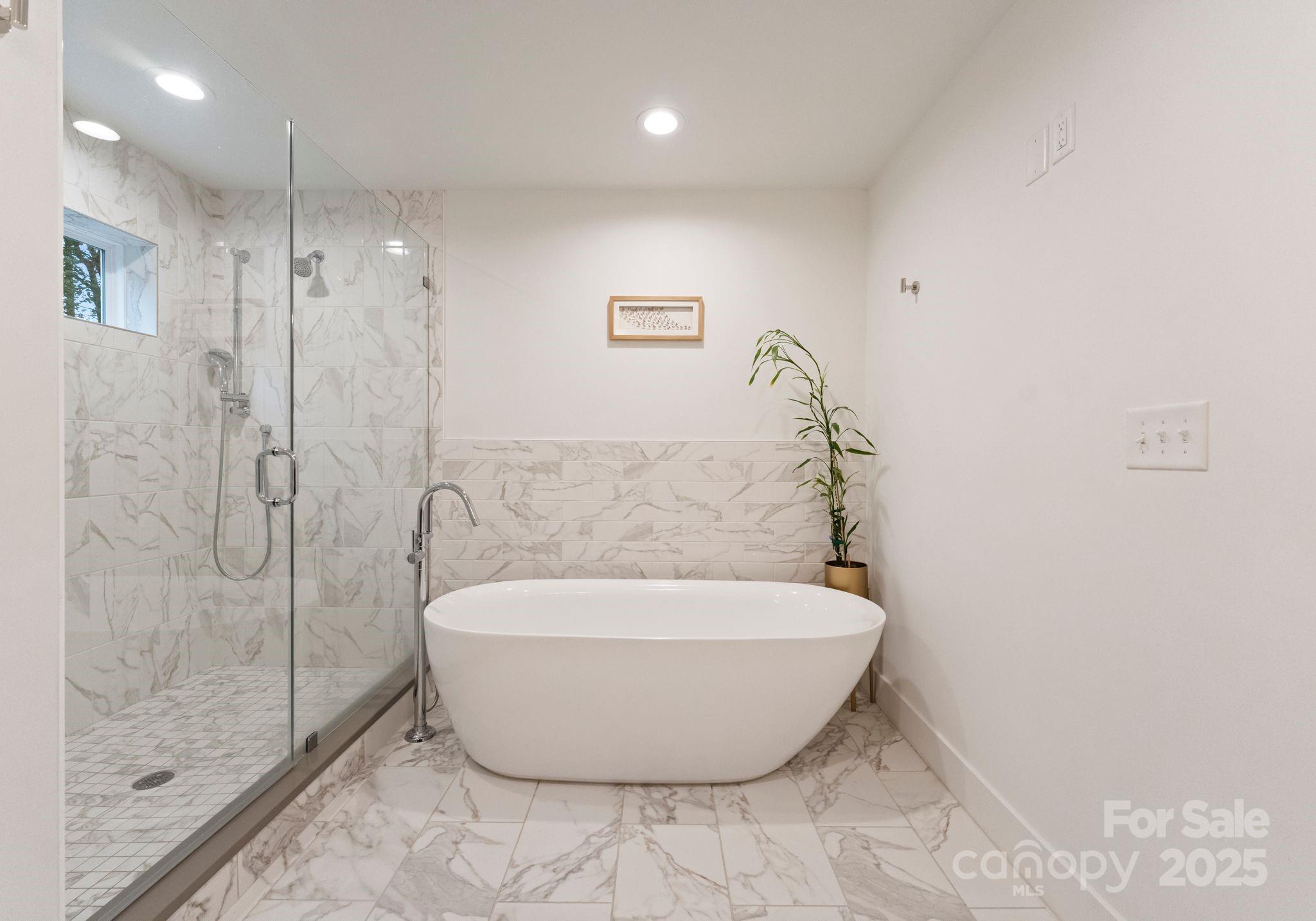 6527 Burlwood Road Charlotte, NC 28211 - Photo 26 of 43 a white bath tub sitting in a bathroom
