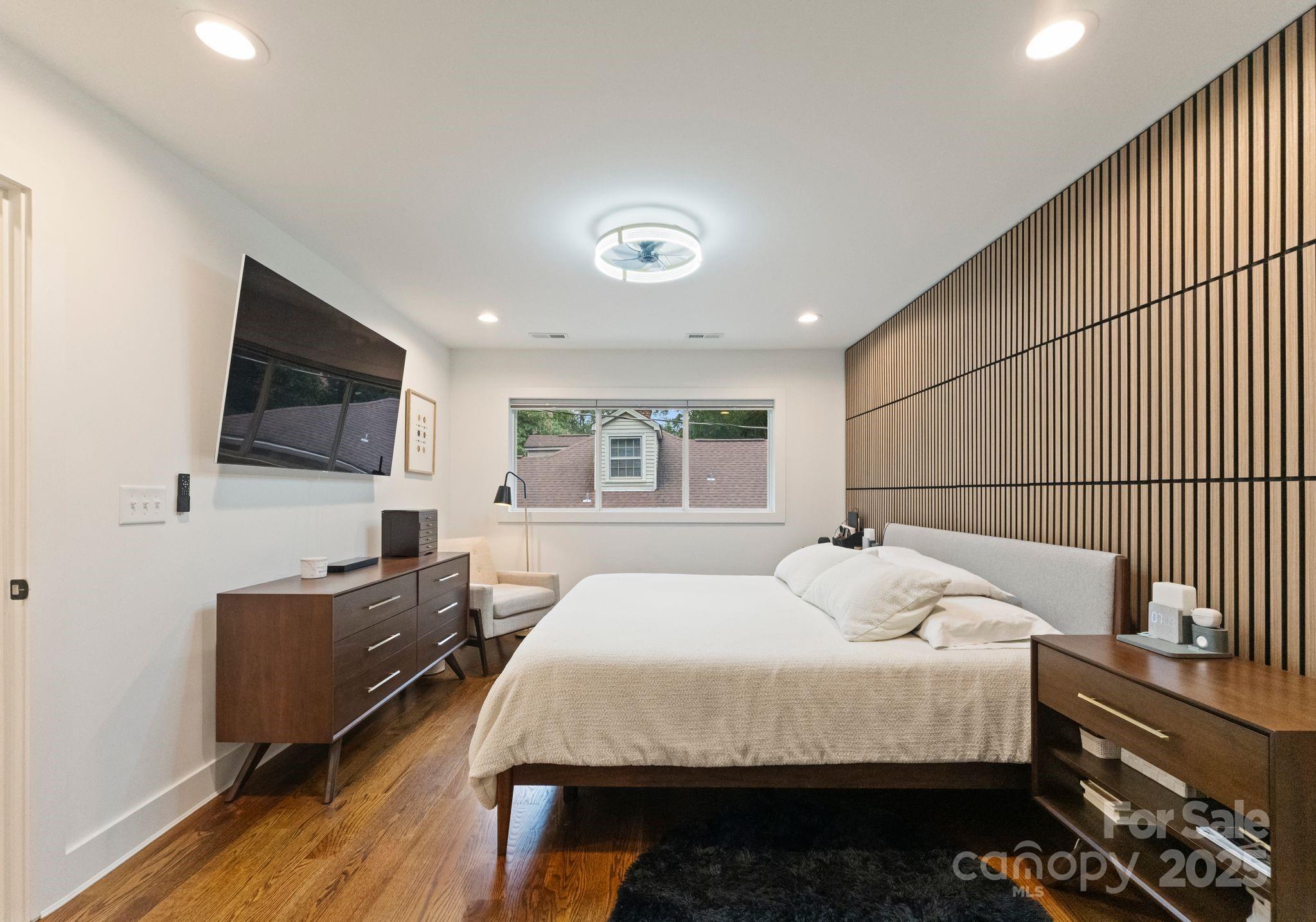 6527 Burlwood Road Charlotte, NC 28211 - Photo 29 of 43 a bedroom with a bed and wooden floor