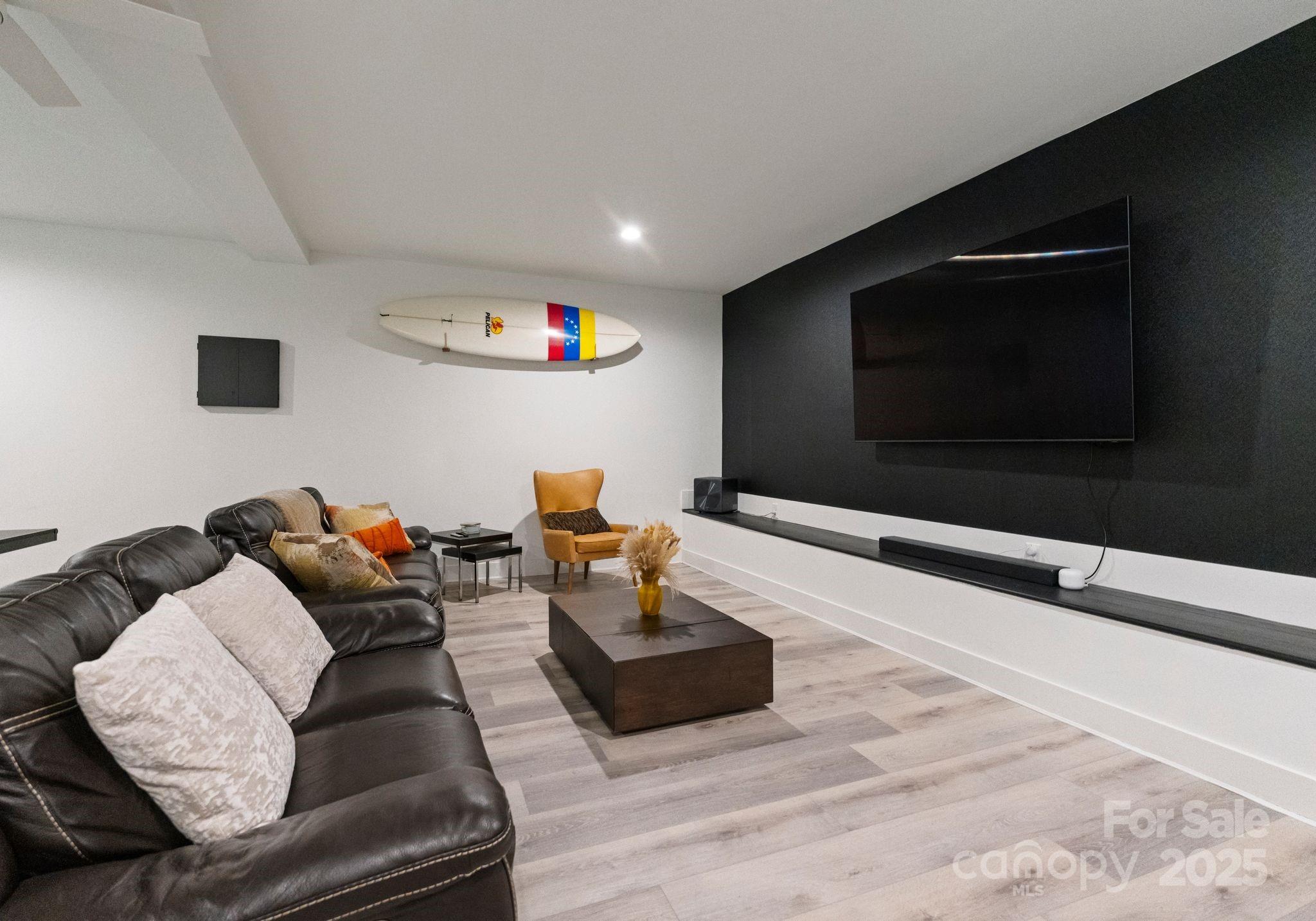 6527 Burlwood Road Charlotte, NC 28211 - Photo 35 of 43 a living room with furniture and a flat screen tv