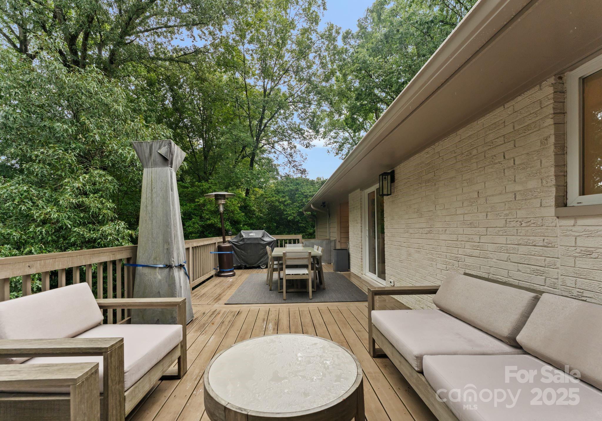 6527 Burlwood Road Charlotte, NC 28211 - Photo 38 of 43 a view of a patio with a table chairs and a backyard