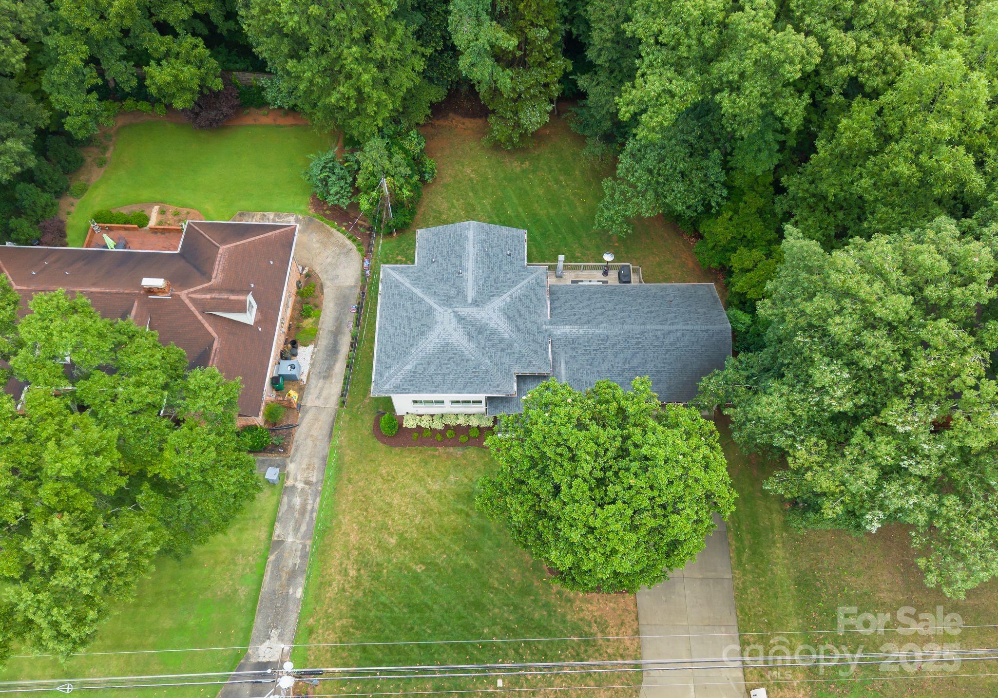 6527 Burlwood Road Charlotte, NC 28211 - Photo 43 of 43 an aerial view of a house with garden space and a lake view