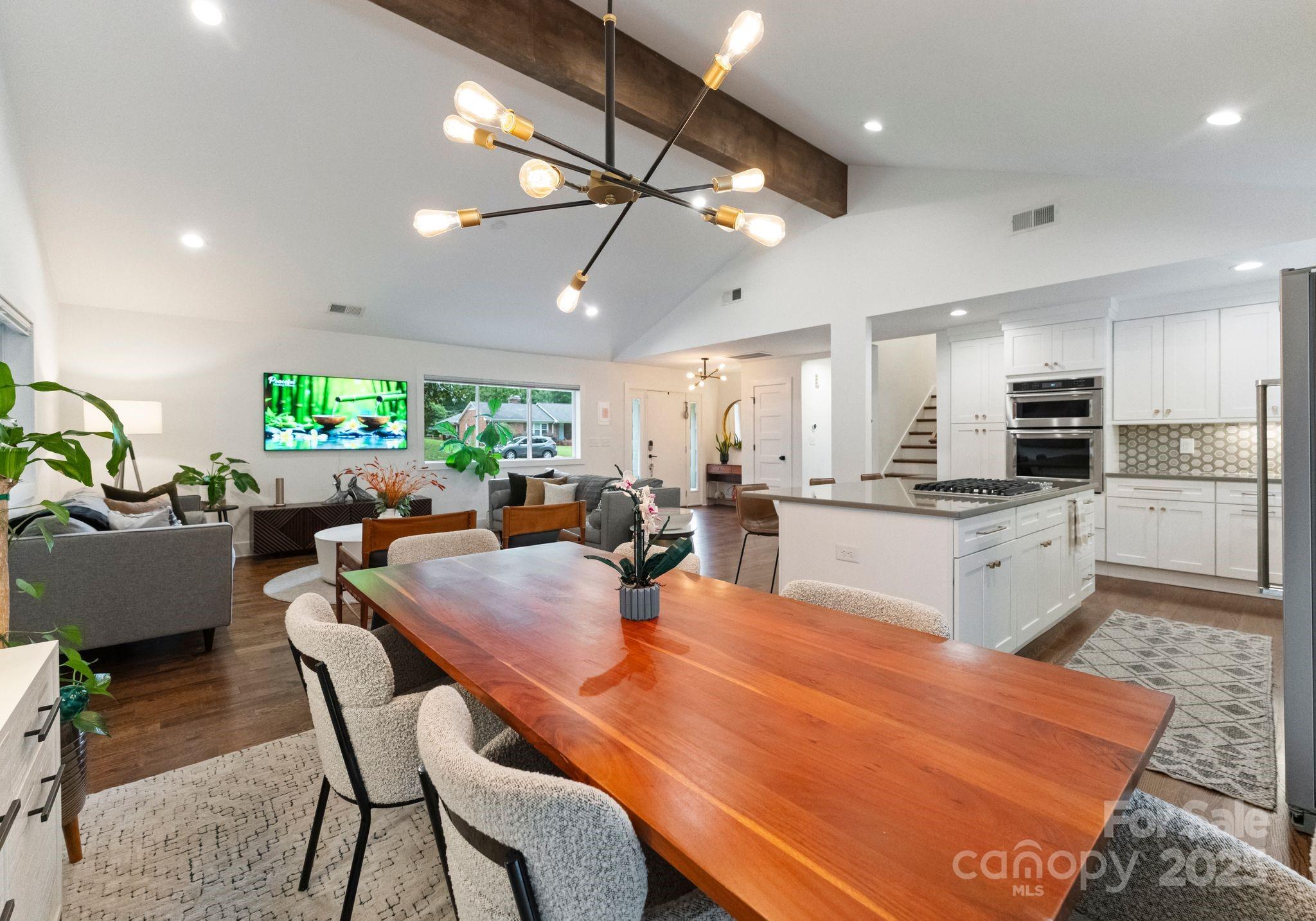 6527 Burlwood Road Charlotte, NC 28211 - Photo 10 of 43 an open kitchen with dining table and chairs