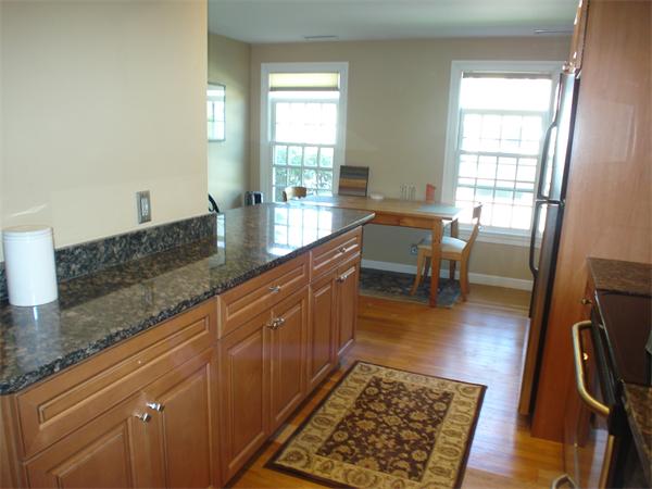 88 Jericho Road, Unit 88 Weston, MA 02493 - Photo 3 of 8 a dining room with granite countertop furniture and a rug