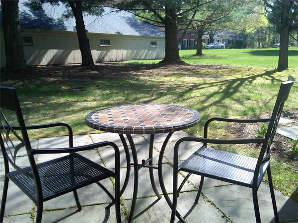 88 Jericho Road, Unit 88 Weston, MA 02493 - Photo 8 of 8 a backyard of a house with table and chairs