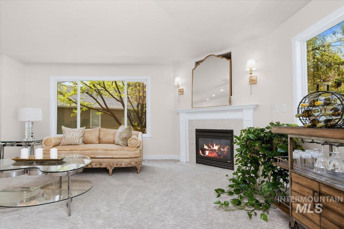 725 North Eagle Road Eagle, ID 83616 - Photo 14 of 45 Living area featuring a prominent fireplace with a classic white mantel, tile surround, and an integrated firebox